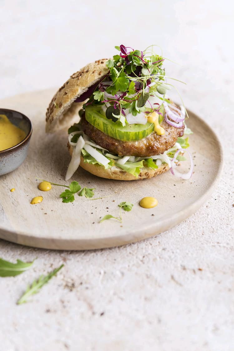 Broodje met een Premium kalkoenburger, frisse groentjes en mosterdsaus